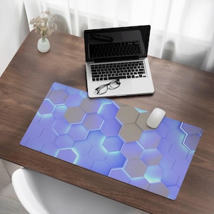 May include: A blue and gray geometric patterned mousepad with a laptop, glasses, and a white mouse on a wooden desk.