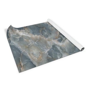 May include: A rolled up sheet of blue and gold marble contact paper. The paper has a realistic marble pattern.