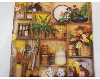 May include: A decorative wooden shelf filled with kitchen and home decor items. Includes jars of preserves, potted plants, a copper kettle, and a basket of flowers. The text "For Your Shower" is visible.