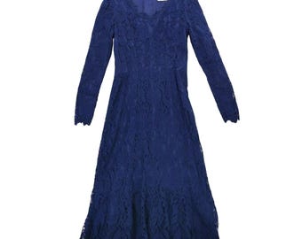 May include: A long-sleeved, navy blue lace dress. The dress features a V-neckline and a flared skirt. The dress is made of a delicate lace fabric and has a vintage aesthetic. The dress is suitable for formal occasions.