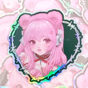 May include: A sticker featuring a pink anime character with bear ears and a choker. The character is surrounded by a barbed wire design with a rainbow iridescent finish.