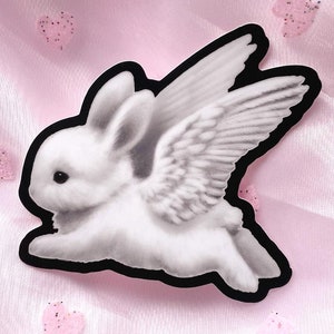 Pegatina de conejo con alas de ángel / Arte de conejito kawaii espeluznante y tierno en vinilo impermeable