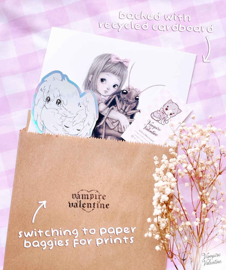 a brown paper bag with a sticker, a drawing of a girl, and some flowers. The bag is labeled "switch to paper bags for prints" and "vampire valentine".