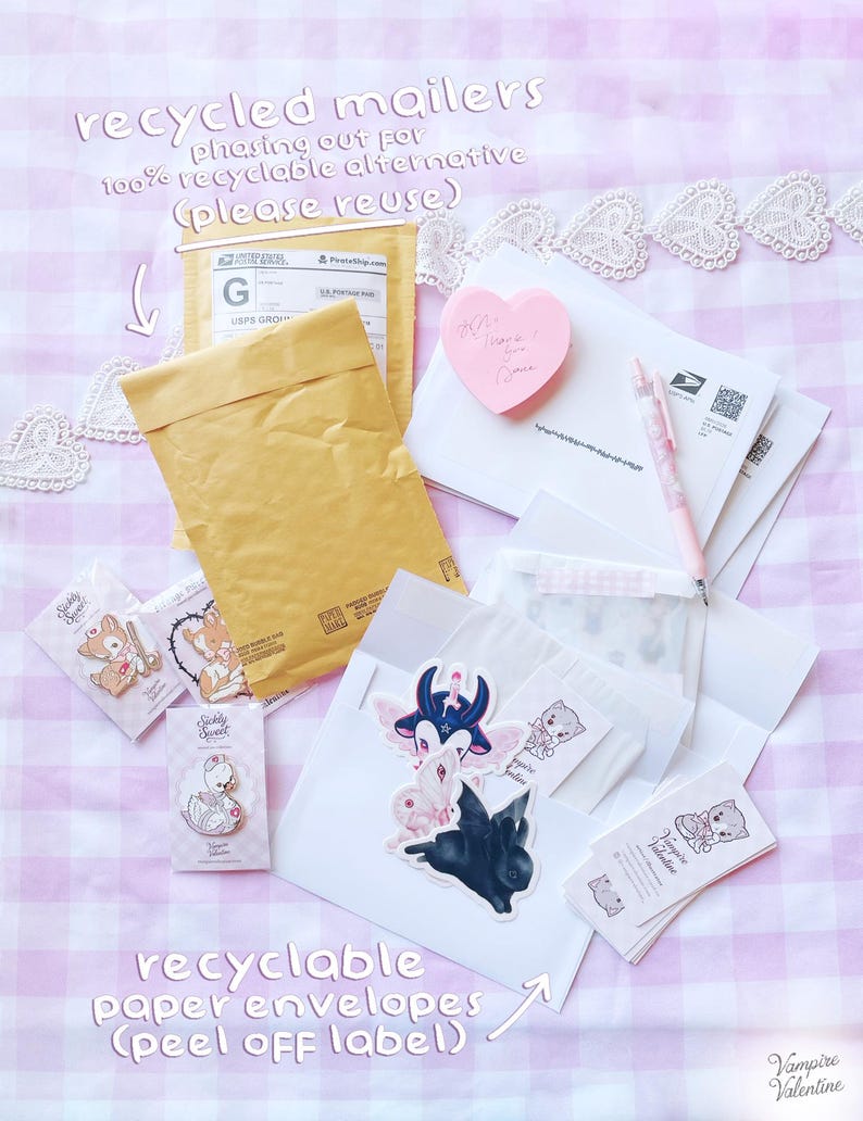 various items related to recycling and reusing, including a recycled mail envelope, a pink heart-shaped sticker, a pen, and some other miscellaneous items.