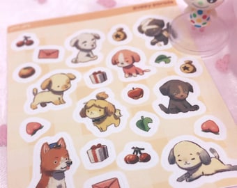 May include: A sticker sheet featuring various illustrated puppies, cherries, apples, gift boxes, envelopes, and leaf icons on a light beige background. A small, pink-eared character figurine stands on a clear circular base next to the sheet.