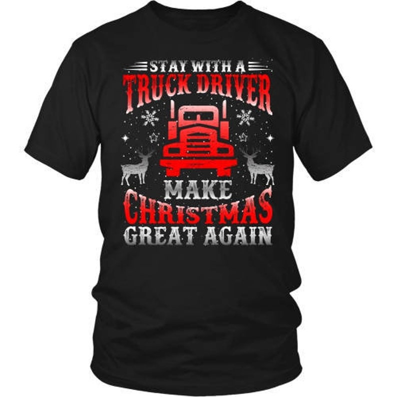 May include: Black t-shirt with a white graphic design featuring a red semi-truck with the text "Stay with a Truck Driver Make Christmas Great Again."