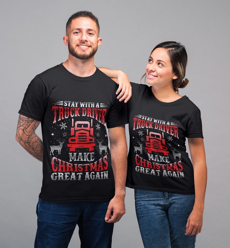 May include: Two black t-shirts with a red truck graphic and the text "Stay with a Truck Driver Make Christmas Great Again".