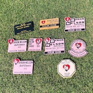 May include: A collection of vintage Byron Nelson Golf Classic pavilion season badges. The badges are in various colors and feature the Byron Nelson logo, the year of the tournament, and the words "Pavilion Season".