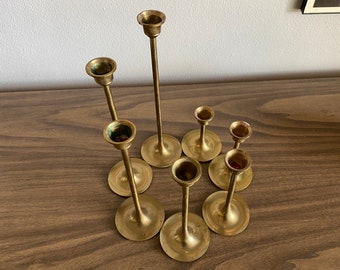 7 graduated brass candlestick holders | round tulip base