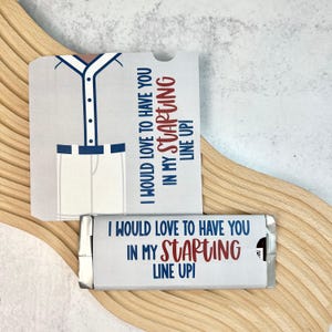 May include: A baseball-themed candy bar wrapper and card set. The card features a jersey design with the text "I WOULD LOVE TO HAVE YOU IN MY STARTING LINE UP!". The candy bar wrapper has the same text.