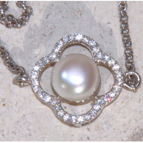 Natural sea shops water pearl and quatrefoil cubic zirconia halo bracelet on fine sterling silver rolo chain.