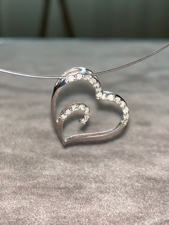 Vintage natural diamonds oblique heart pendant in 