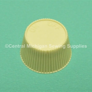 May include: A white plastic knob with the words "ON" and "OFF" printed on the top. The knob has a fluted edge.