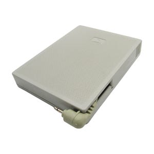 May include: A gray rectangular battery pack with a textured surface and a black cord with a 3.5mm jack.