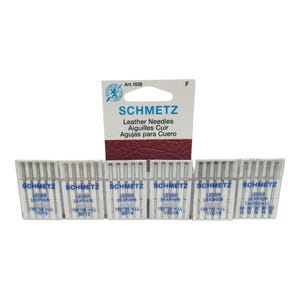 May include: A pack of six boxes of Schmetz leather needles, each box containing 10 needles. The boxes are labelled with the size and type of needle, including "130/705 H LL" and "LEDER LEATHER".