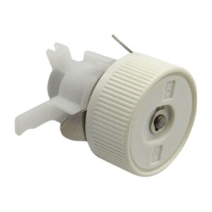 May include: A white plastic component with a ridged, cylindrical cap and a metal clip. The cap has two small, square markings. A thin metal wire extends from the top. The component is designed for a specific mechanical function.