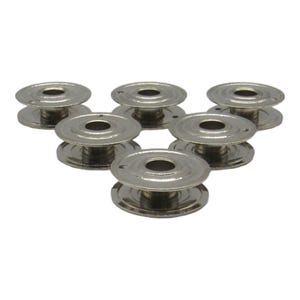 May include: Six silver metal bobbins for a sewing machine.