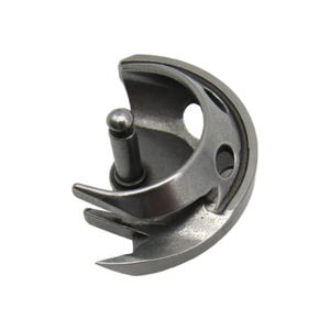 May include: A silver metal bobbin case for a sewing machine. The bobbin case has a hook and a small metal pin.