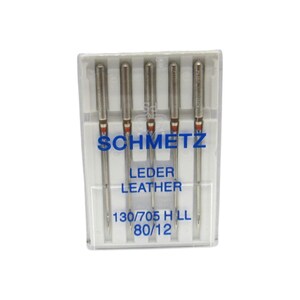 May include: A pack of five silver sewing needles for leather, labeled "Schmetz Leder Leather 130/705 H LL 80/12".