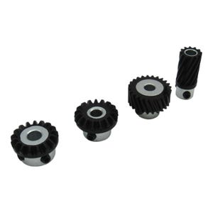 May include: Four black and silver gears of varying sizes are arranged on a white background. The gears have a toothed outer edge and a central hole. The gears are made of black plastic and silver metal.