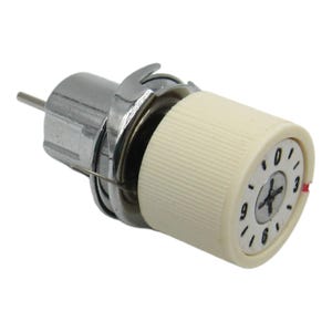 May include: A white bobbin winder with a silver metal base and a numbered dial. The dial has numbers 0-9 and a red arrow pointing to the number 3.