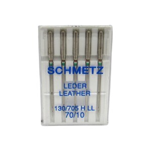 May include: A pack of five silver sewing needles in a clear plastic case. The needles are labeled "SCHMETZ LEDER LEATHER 130/705 H LL 70/10".