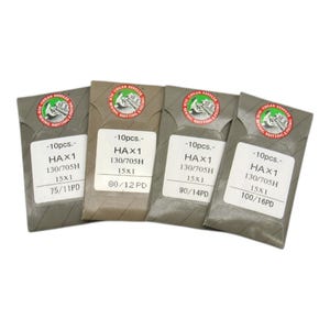 May include: Four packets of sewing machine needles, each labeled with "HAX1 130/705H 15x1" and needle size. The packets are in shades of gray and brown, with a circular logo and text indicating the needle type and quantity.