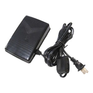 May include: Black foot pedal with a cord and plug. The foot pedal has the word "ELECTRONIC" printed on it.