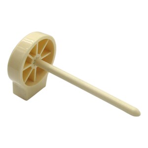 May include: A white plastic bottle stopper with a round base and a long, thin, pointed rod extending from the center. The base has a circular opening with a series of spokes radiating outward.