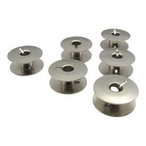 May include: A set of eight silver metal bobbins for a sewing machine.
