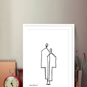 May include: A black and white line drawing of two figures standing side by side. The drawing is framed in a white frame and signed "Banfischel 2017" in the bottom left corner.