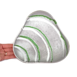 May include: A triangular ceramic serving dish with a gray glaze and green and white painted lines.