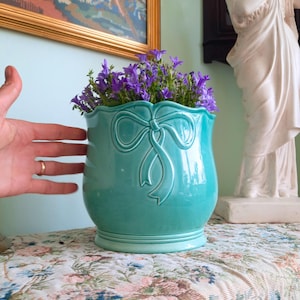 May include: A trio of ceramic mugs with a speckled, matte finish in cream, light grey, and dark grey. The mugs have a simple, minimalist design, ideal for tea or coffee.