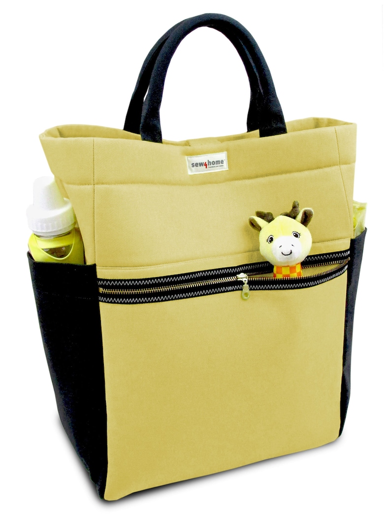 May include: A beige canvas tote bag with black trim and a zippered pocket. The bag has a black handle and a small yellow and orange stuffed animal attached to the zipper. The bag has the text "sew4home" printed on the front.