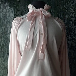 1970s womens stretchy high frilled neck light pink full long sleeved secretary blouse with kitten bow