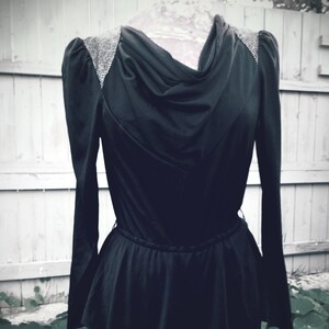 80s Glam: Black Puffed Shoulder Vintage Pantsuit with Flounce - Unleash your inner style icon with this bold and iconic statement piece!