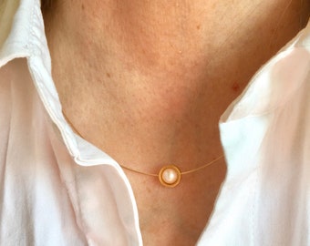 Pearl necklace. A freshwater pearl in a round gold pipe on a wire of gold. You can vary the lenght by yourself.