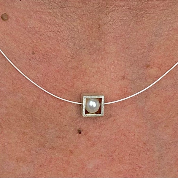 Pearl necklace. Genuine pearl in a silver square on a wire of gold. You can vary the lenght by yourself.