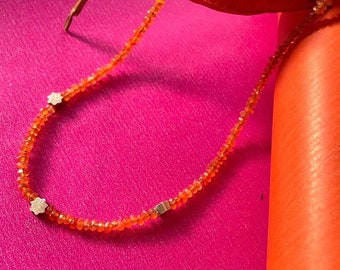 Carnelian string with goldflowers between and a hand forged claps