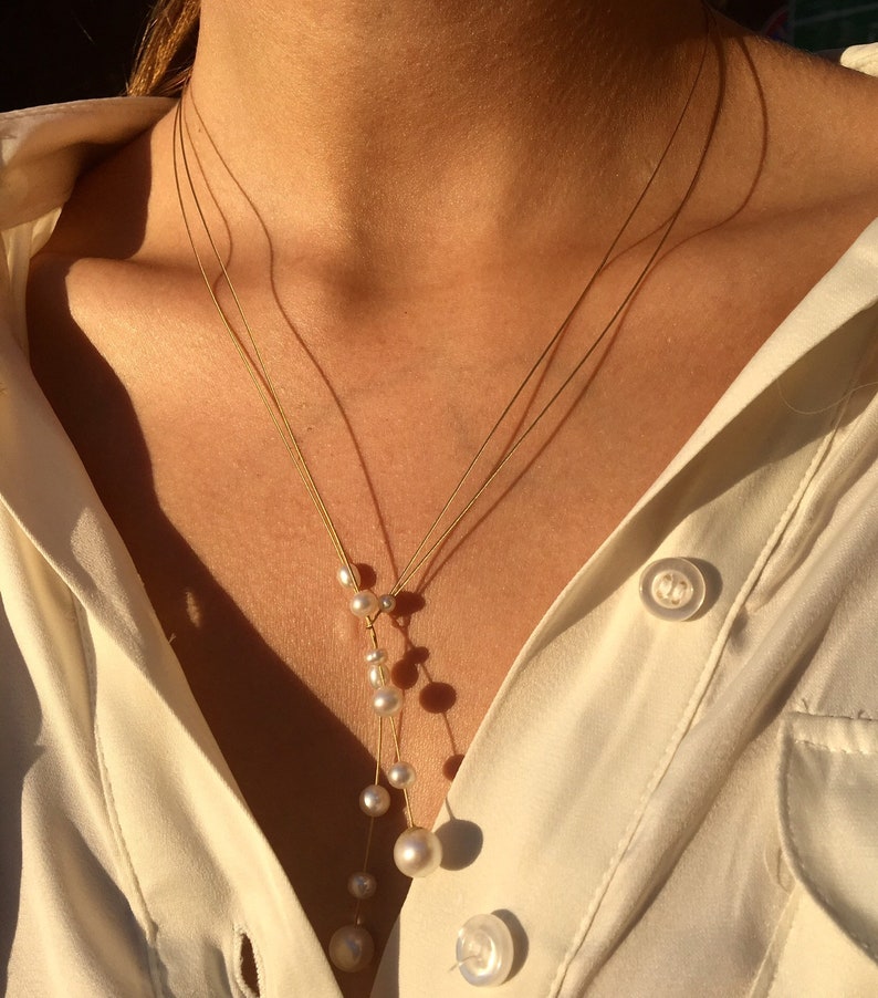 Pearl necklace. Freshwater pearls on a wire of gold. You can vary the lenght by yourself, by fixing one end on a position. Lariat necklace Bild 3