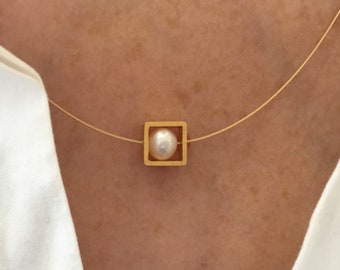 Pearl necklace. Genuine pearl in a gold square on a wire of gold. You can vary the lenght by yourself.