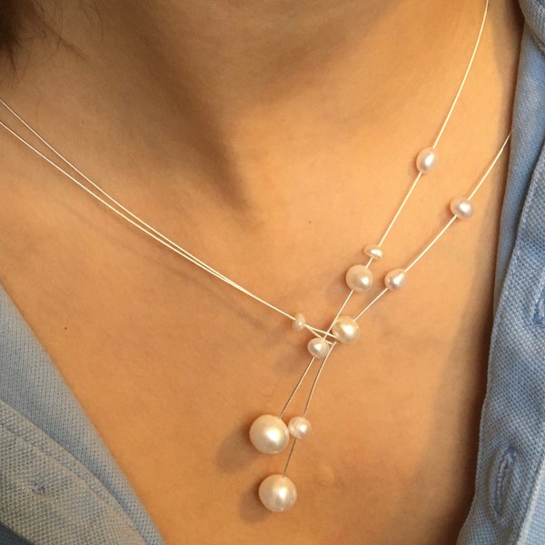 Dainty pearl necklace. Freshwater pearls on a wire of silver. You can vary the lenght by yourself, by fixing one end on a position.