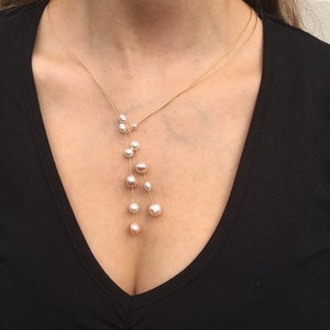 Jewelry Set. Pearl necklace on a wire of gold and a gold ring with freshwater pearl. image 6