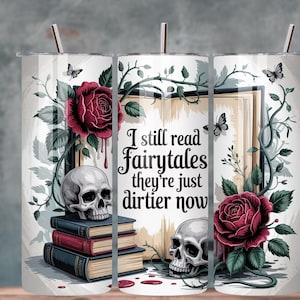Può includere: Un bicchiere bianco con un disegno raffigurante un teschio, rose, farfalle e libri. Il testo recita: "I still read fairytales they're just dirtier now". Il design è nei toni del rosso, nero e grigio.