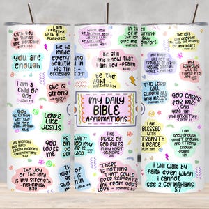 May include: A white tumbler with a lid and straw, featuring colorful affirmations and Bible verses. The words "My Daily Bible Affirmations" are prominently displayed. The design includes various pastel-colored shapes and text.