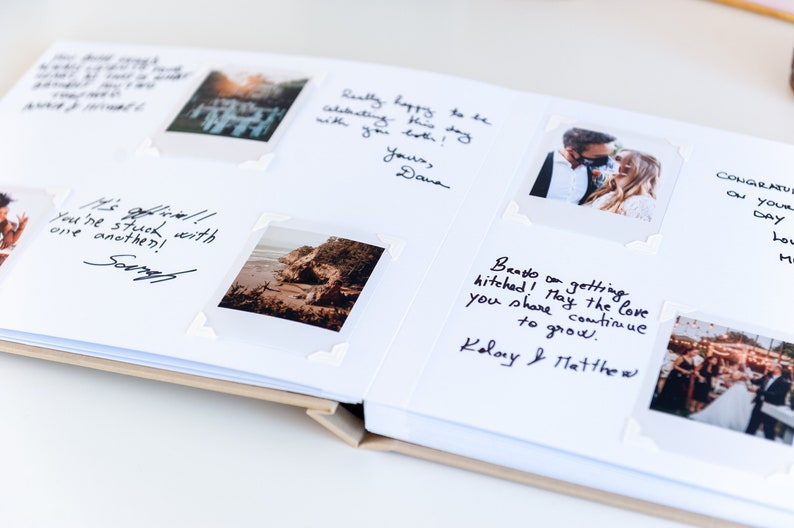 May include: Open wedding guest book with photos and handwritten messages. Photos are attached with white corner stickers. Messages include "You're stuck with one another!" and "Bands on getting hitched! May the love you share continue to grow."
