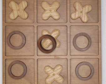 Wooden TIC-TAC-TOE board and pieces.