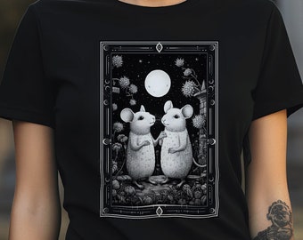 May include: Black t-shirt with a graphic of two mice standing under a full moon. The graphic is in black and white and features a moon with stars and a forest scene.
