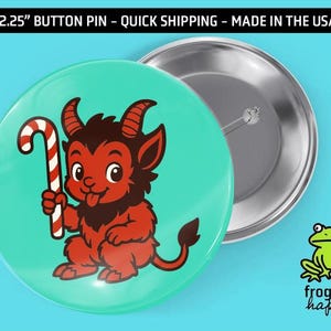 May include: A 2.25-inch button pin with a cartoon devil holding a candy cane on a teal background. The devil is red with brown fur and horns. The pin is made in the USA.