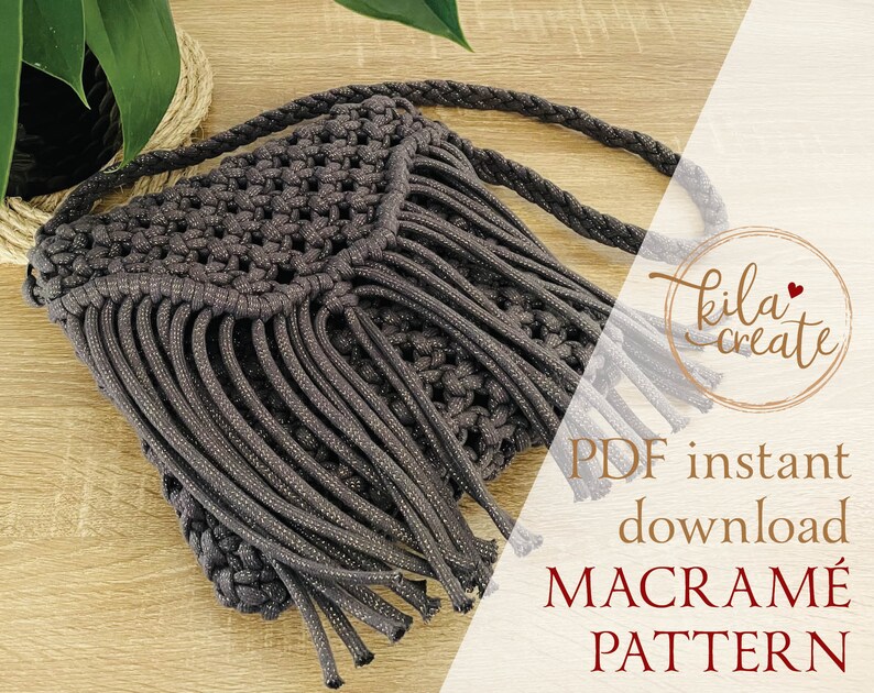 Puede incluir: Un bolso de macram&eacute; gris con flecos en la parte inferior y una correa trenzada. El bolso est&aacute; sobre una superficie de madera. El texto "PDF descarga instant&aacute;nea PATR&Oacute;N DE MACRAM&Eacute;" est&aacute; sobre un fondo blanco.